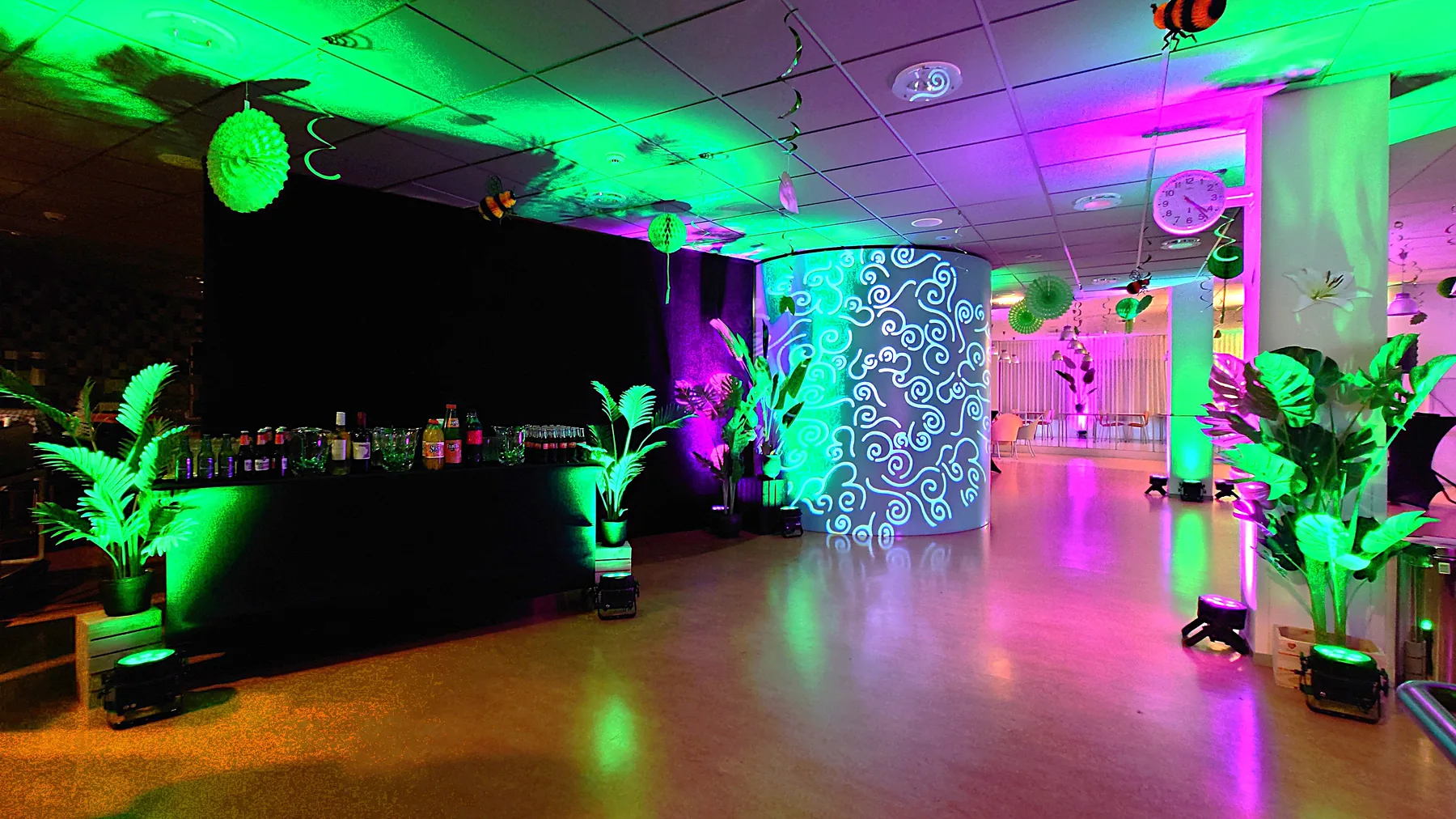 Restyled BovenIJ restaurant with plants, drapes and green-pink atmospheric lighting