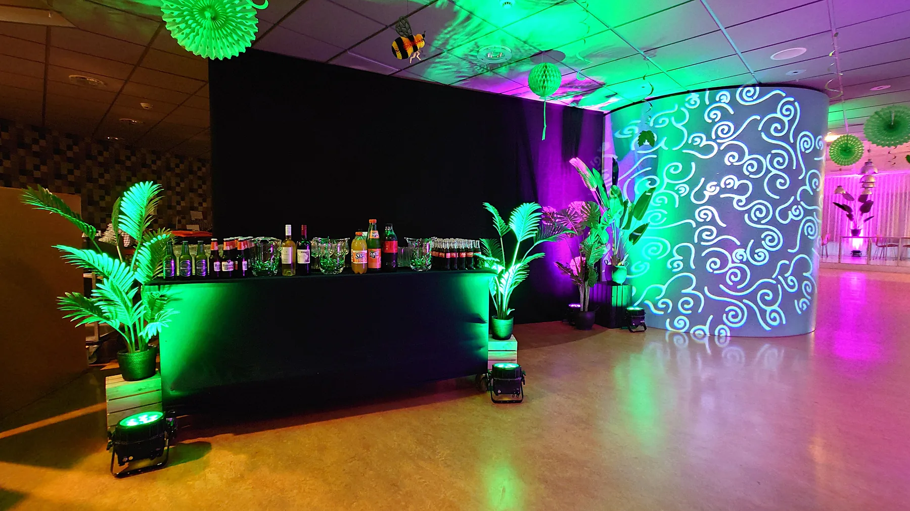 Bar with pipe and drape, plants and a light projection