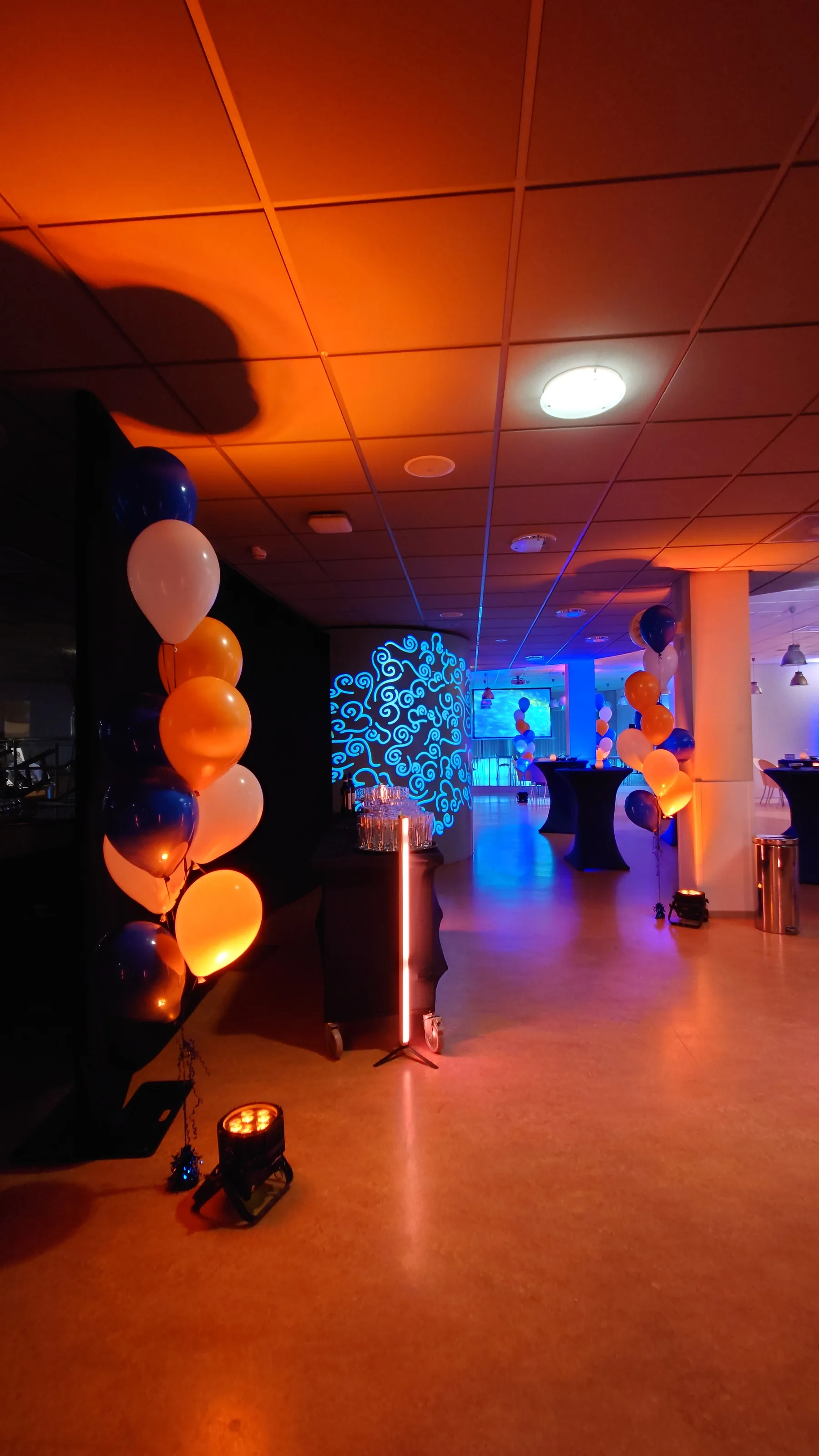 Entrance with balloons and orange-blue atmospheric lighting