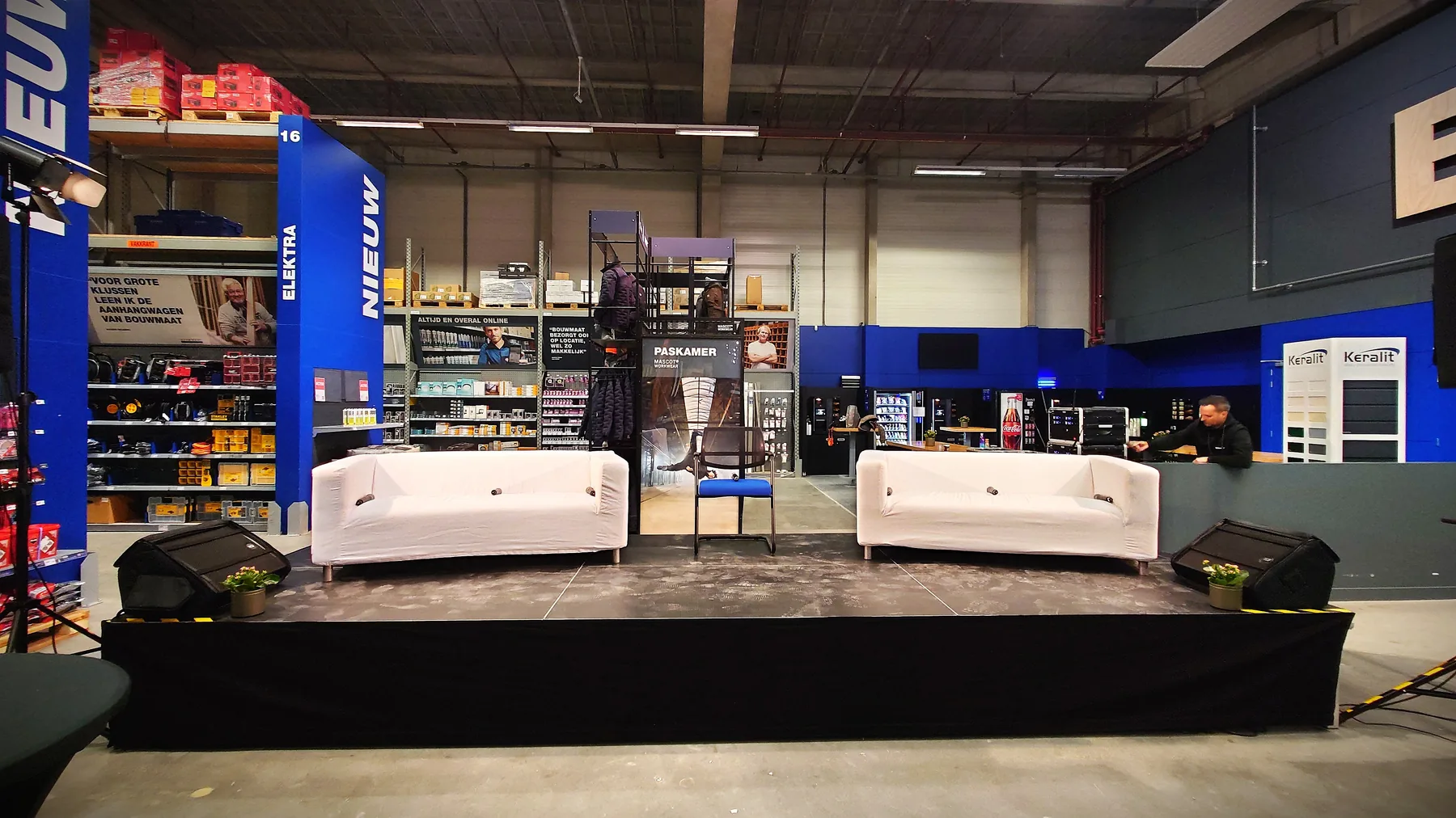 Stage arrangement with sofas, chair, monitors and speakers