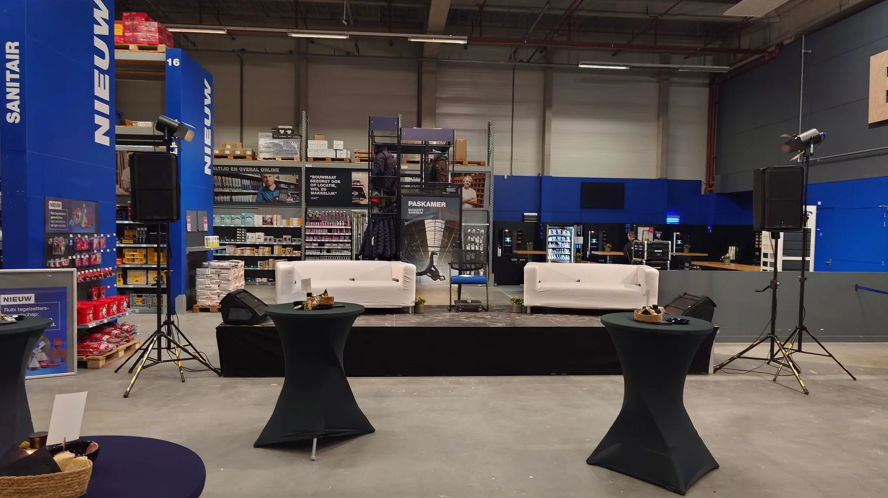 Stage with lighting, sound and standing tables at the company venue