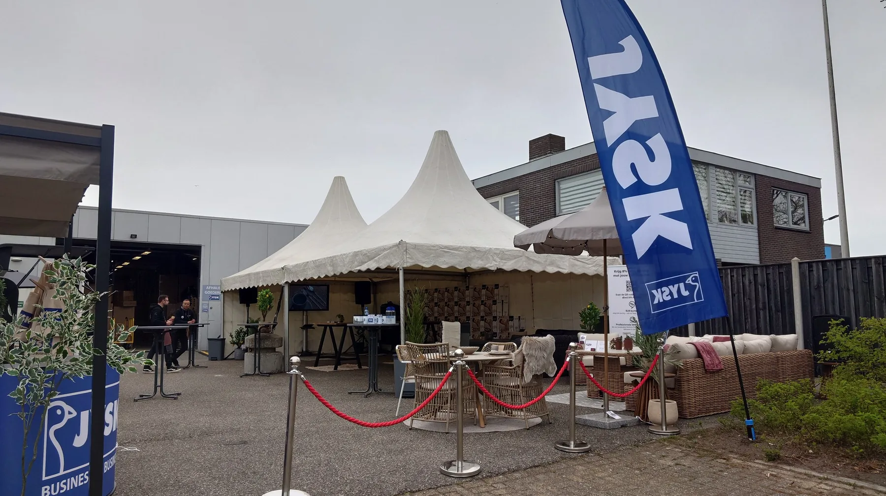 Entrance with marquee, furniture and green styling