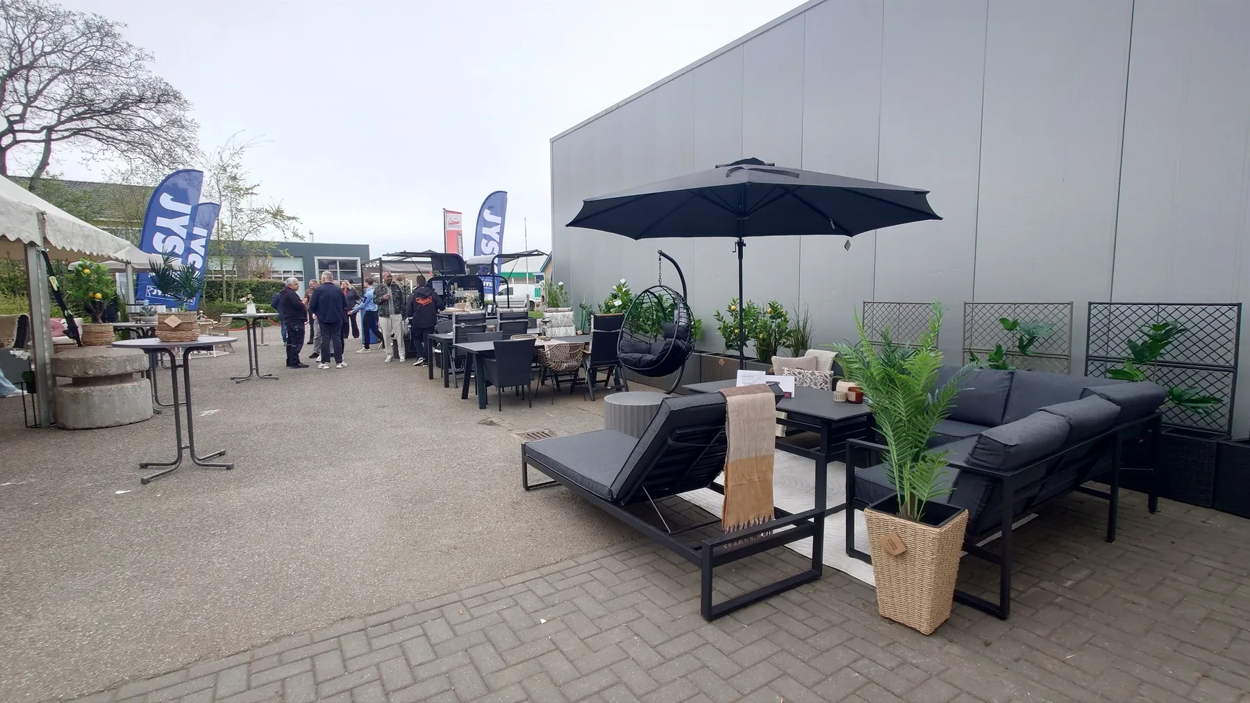 Outdoor space with lounge furniture, plants and guests
