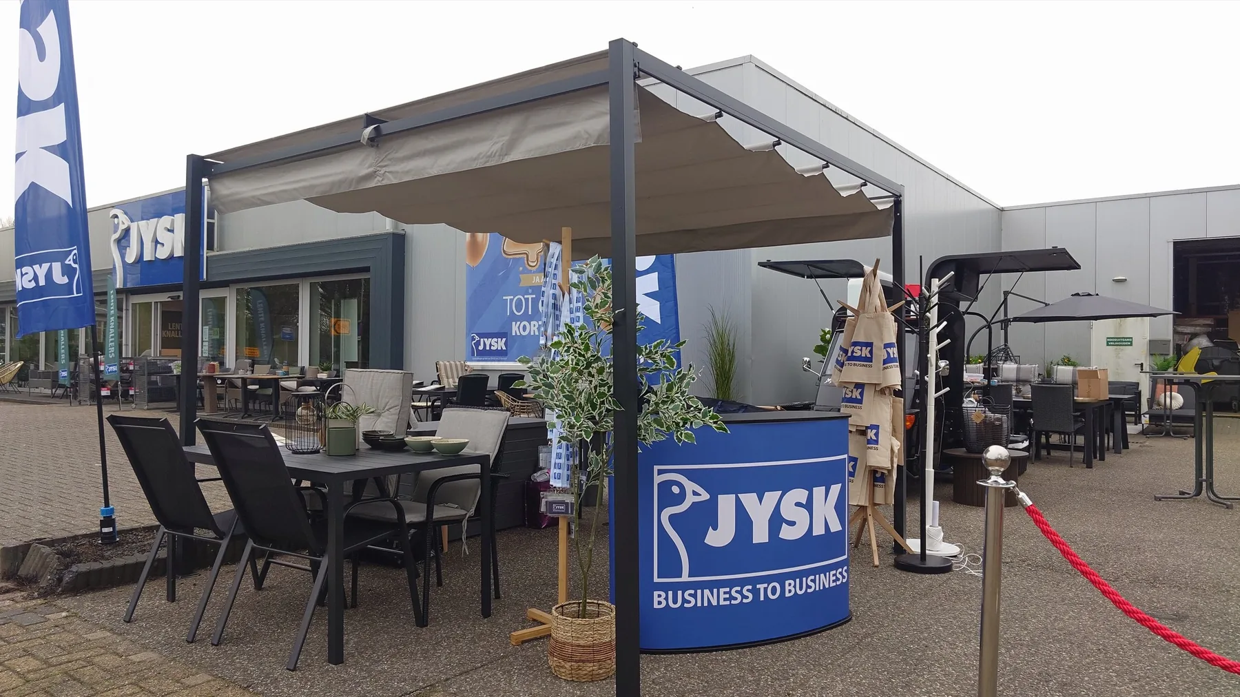 Event entrance with welcome desk, coffee cart and furnished terrace